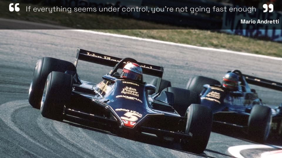 The slide: a black and gold Formula 1 car cornering at speed, with the quote "If everything seems under control, you're not going fast enough" across the top and Mario Andretti's name beneath it.